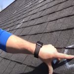 Roof inspection for repairs by worker pointing out issues on the roof