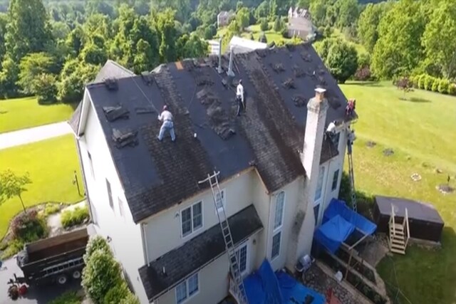 Shingle Re-roofing on big home by multiple workers